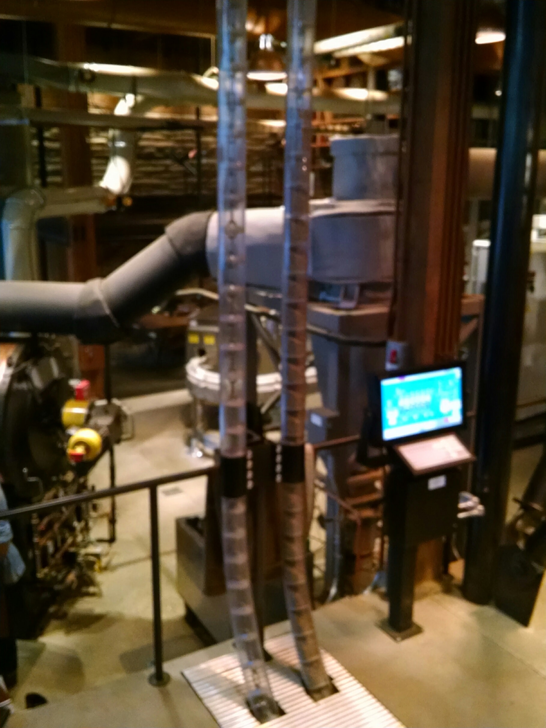 The vacuum tubes that gently move the beans around the roastery next to the computer control panel. 