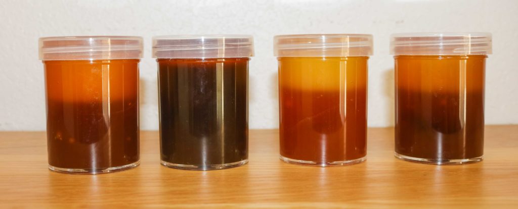 L to R: The first vial is Briess CBW® Gold Light LME that is two months old. It maintains a amber, red color with proper storage. The second vial from the left is also CBW® Gold Light LME after it has been stored for two years - is a dark mahogany color and is no longer good. The third vial is of CBW® Pilsen Light LME that is aged for two months and the fourth vial is CBW® Pilsen Light LME that is aged for two years. The aged Pilsen is also much darker than the two month old Pilsen.